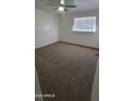 Comfortable bedroom featuring fresh carpeting, a ceiling fan, and a bright window at 2908 N 53Rd Ln, Phoenix, AZ 85031