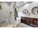 Spa-like bathroom with a walk-in shower, soaking tub, and dual vanity sinks at 3010 W Laredo Ln, Phoenix, AZ 85085