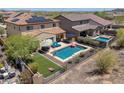 Aerial view showcasing a private pool, well-manicured backyard, and neighborhood at 31046 N 138Th Ave, Peoria, AZ 85383