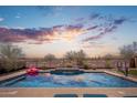 Relaxing pool with a serene water feature, perfect for evening swims with a stunning sunset backdrop at 31046 N 138Th Ave, Peoria, AZ 85383