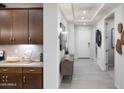 Bright hallway with tile floors, modern lighting, and entry to the kitchen at 4961 W Walatowa St, Laveen, AZ 85339
