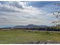 Expansive community park with walking trails and mountain views in the distance at 5827 W Coplen Farms Rd, Laveen, AZ 85339
