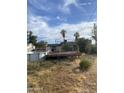 Backyard of the property with an above-ground pool, a deck, and desert landscaping at 8022 E 1St Ave, Mesa, AZ 85208