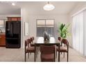 Staged dining area featuring table with seating for six, and natural light from the window at 8104 S 73Rd Dr, Laveen, AZ 85339