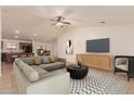Spacious living room featuring a vaulted ceiling, tile flooring and modern furniture at 8104 S 73Rd Dr, Laveen, AZ 85339