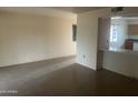 Spacious living room featuring tile floors, neutral walls, and an open view to the kitchen at 10012 W Lakeview Cir, Sun City, AZ 85351