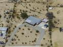 Spacious rural property with a manufactured home, large driveway, and multiple storage units at 10622 N Malachite Way, Casa Grande, AZ 85122