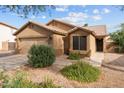 Inviting single-story home with a well-maintained yard, two-car garage, and desert landscaping at 11405 W Windsor Ave, Avondale, AZ 85392