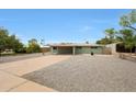 Single story home features an arid front yard and a covered driveway at 1320 E Butler Dr, Phoenix, AZ 85020