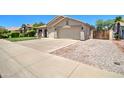 This single-story home has a well-maintained lawn and a spacious two-car garage at 14298 W Amelia Ave, Goodyear, AZ 85395