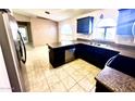 Kitchen with stainless steel appliances, granite countertops, and tiled floors at 18166 W Camino Real Dr, Surprise, AZ 85374