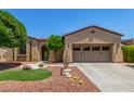 Charming single-story home featuring a well-manicured yard with desert landscaping and a spacious two-car garage at 30135 N 129Th Gln, Peoria, AZ 85383