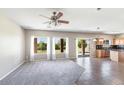 Open-concept living room with carpet and tile flooring, seamlessly connecting to the kitchen at 30375 W Verde Ln, Buckeye, AZ 85396