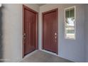 Close-up of two doors inside the entry of a home with a small window on the right at 3260 W Caleb Rd, Phoenix, AZ 85083