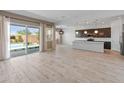 Open concept living area with tile floors, sliding glass doors to the pool, and gourmet kitchen at 3260 W Caleb Rd, Phoenix, AZ 85083