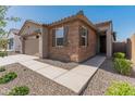A front exterior view highlights the desert landscaping and architectural details of this single-Gathering home at 3264 W Caleb Rd, Phoenix, AZ 85083