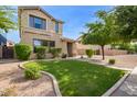 Beautiful home with a lush green lawn and a decorative rock border at 3443 E Jasper Dr, Gilbert, AZ 85296