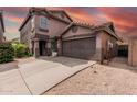 Attractive two-story home with a two-car garage, landscaping gravel and a neutral stucco exterior under a vibrant sky at 3488 S Bowman Rd, Apache Junction, AZ 85119