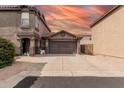 Well-maintained two-story home featuring a two-car garage, low-maintenance landscaping, and a neutral exterior under a colorful sky at 3488 S Bowman Rd, Apache Junction, AZ 85119