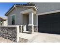 Beautiful single-Gathering home exterior showcasing a two-car garage and decorative stone accents at 3914 E French Trotter St, San Tan Valley, AZ 85140