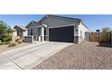 Well-maintained single-story house featuring a gray garage door and desert rock landscaping at 3914 E French Trotter St, San Tan Valley, AZ 85140