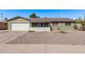 Charming single-story home featuring a desert landscape and a convenient two-car garage at 4004 W Myrtle Ave, Phoenix, AZ 85051