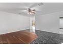 A living room with light walls, stylish flooring and ceiling fan at 4004 W Myrtle Ave, Phoenix, AZ 85051