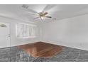 A living room with light walls, stylish flooring and ceiling fan at 4004 W Myrtle Ave, Phoenix, AZ 85051