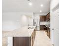 Spacious kitchen with stainless steel appliances, granite counters, and an extended island at 42925 W Palo Amarillo Rd, Maricopa, AZ 85138