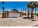 Single-story home with a two-car garage and low-maintenance desert landscaping at 4702 W Northview Ave, Glendale, AZ 85301