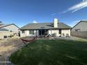 Spacious backyard with artificial grass, patio area and outdoor seating perfect for entertaining at 4928 E Princess Dr, Mesa, AZ 85205