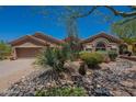 Single story home with desert landscaping features mature native plants and gravel at 5336 E Gloria Ln, Cave Creek, AZ 85331