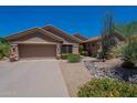 Single story home with low maintenance gravel landscaping and a two car garage at 5336 E Gloria Ln, Cave Creek, AZ 85331