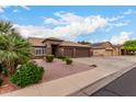 Charming single-story home featuring a three-car garage, desert landscaping, and mature trees at 5536 E Gable Ave, Mesa, AZ 85206