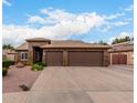 Charming single-story home featuring a three-car garage and desert landscaping at 5536 E Gable Ave, Mesa, AZ 85206