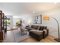 Bright living room with stylish decor, wood floors, and an open view into the adjacent dining area at 6055 E Vernon Ave, Scottsdale, AZ 85257