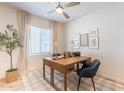 Bright home office with a wood desk, a ceiling fan, neutral walls, and a plaid rug at 670 W Laredo St, Chandler, AZ 85225