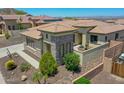 Stunning single-story home featuring desert landscaping, covered patio, and a fountain feature at 6914 W Juana Dr, Peoria, AZ 85383