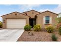 Charming single-story home featuring desert landscaping, a two-car garage, and a welcoming front entrance at 7216 N 124Th Ln, Glendale, AZ 85307