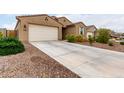Single-story home featuring desert landscaping, a two-car garage, and extended driveway at 7216 N 124Th Ln, Glendale, AZ 85307
