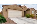 Single-story home featuring desert landscaping, a two-car garage, and extended driveway at 7216 N 124Th Ln, Glendale, AZ 85307