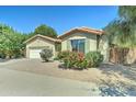 Inviting single-story home featuring gravel landscaping, shutters, and mature trees at 7815 S 22Nd Ln, Phoenix, AZ 85041