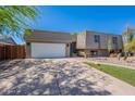 Charming home featuring a spacious driveway, desert landscaping, and a two-car garage at 8307 E Buena Terra Way, Scottsdale, AZ 85250