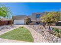 Stylish home featuring desert landscaping with a paved walkway and spacious two-car garage at 8307 E Buena Terra Way, Scottsdale, AZ 85250