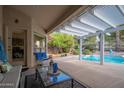 Enjoy a covered patio with serene pool views, perfect for outdoor dining and relaxation at 835 W Beechnut Dr, Chandler, AZ 85248