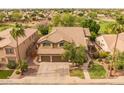 A beautiful aerial view of this home, showcasing the tile roof, backyard, and surrounding neighborhood at 9708 E Pampa Ave, Mesa, AZ 85212