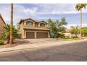 Charming two-story home showcasing manicured landscaping, a desert tree, and an attached two-car garage at 9708 E Pampa Ave, Mesa, AZ 85212