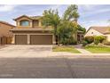 Lovely two-story house features a tiled roof, a well-manicured lawn, mature trees and a two-car garage at 9708 E Pampa Ave, Mesa, AZ 85212
