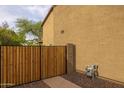 View of the side yard, featuring the side of the home, a gate, and the meter at 9708 E Pampa Ave, Mesa, AZ 85212