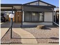 Cozy home featuring a carport, walkway, and low maintenance desert landscaping at 10951 N 91St Ave # 255, Peoria, AZ 85345